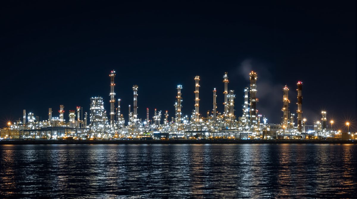 Petrochemical refinery and industrial complex reflecting in Corpus Christi Bay at night — Gregory Texas San Patricio County industrial corridor