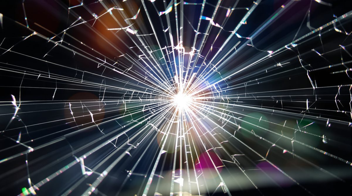 Dramatic starburst crack pattern in windshield glass catching brilliant light — windshield crack repair Corpus Christi TX